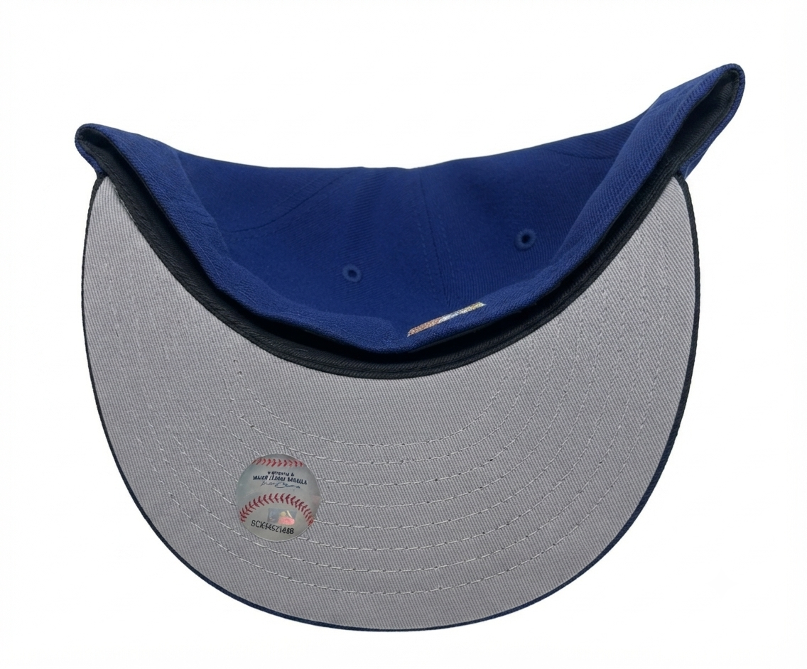 New Era 59FIFTY fitted hat for the New York Yankees features a royal blue crown, a black visor, and a commemorative 1999 World Series side patch.