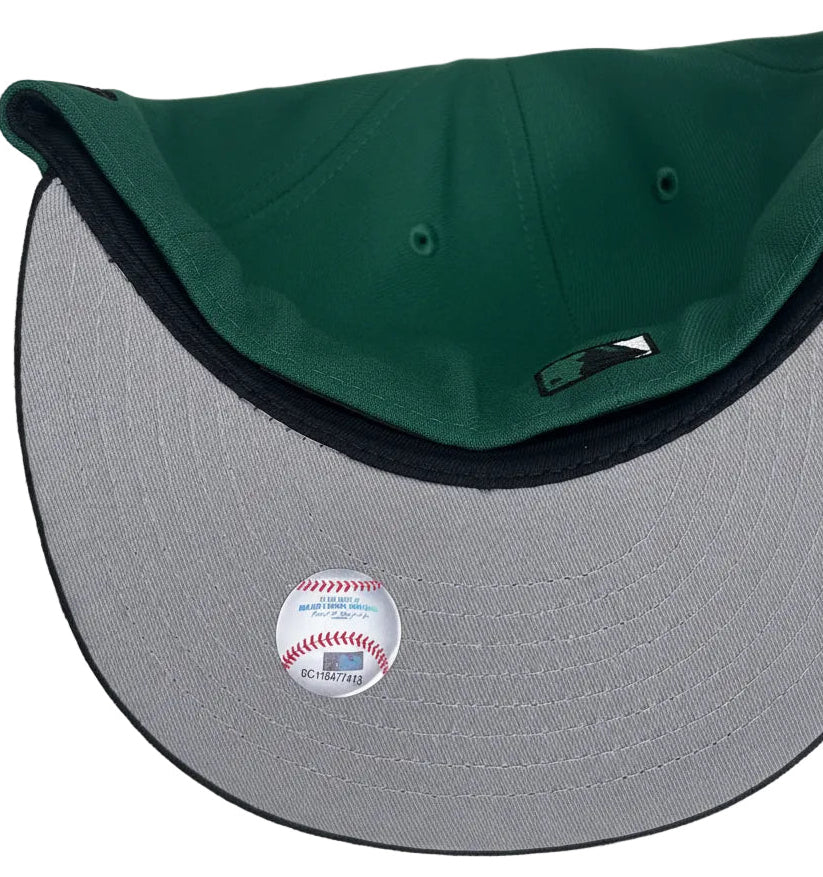 New Era Los Angeles Dodgers 59FIFTY fitted cap featuring a green crown, black visor, and an upside-down white logo.