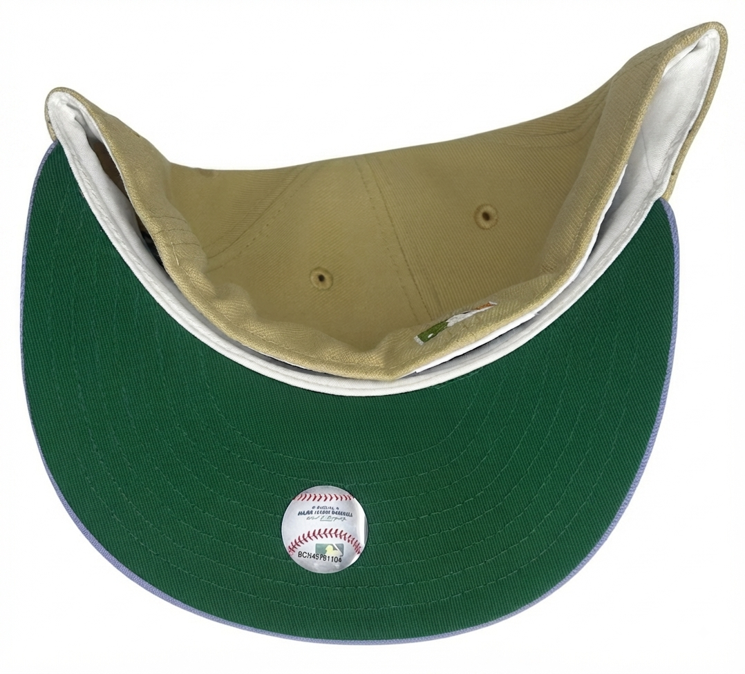 New Era Seattle Mariners 59FIFTY fitted hat features a khaki-tan crown and a pastel lavender visor with a commemorative side patch.