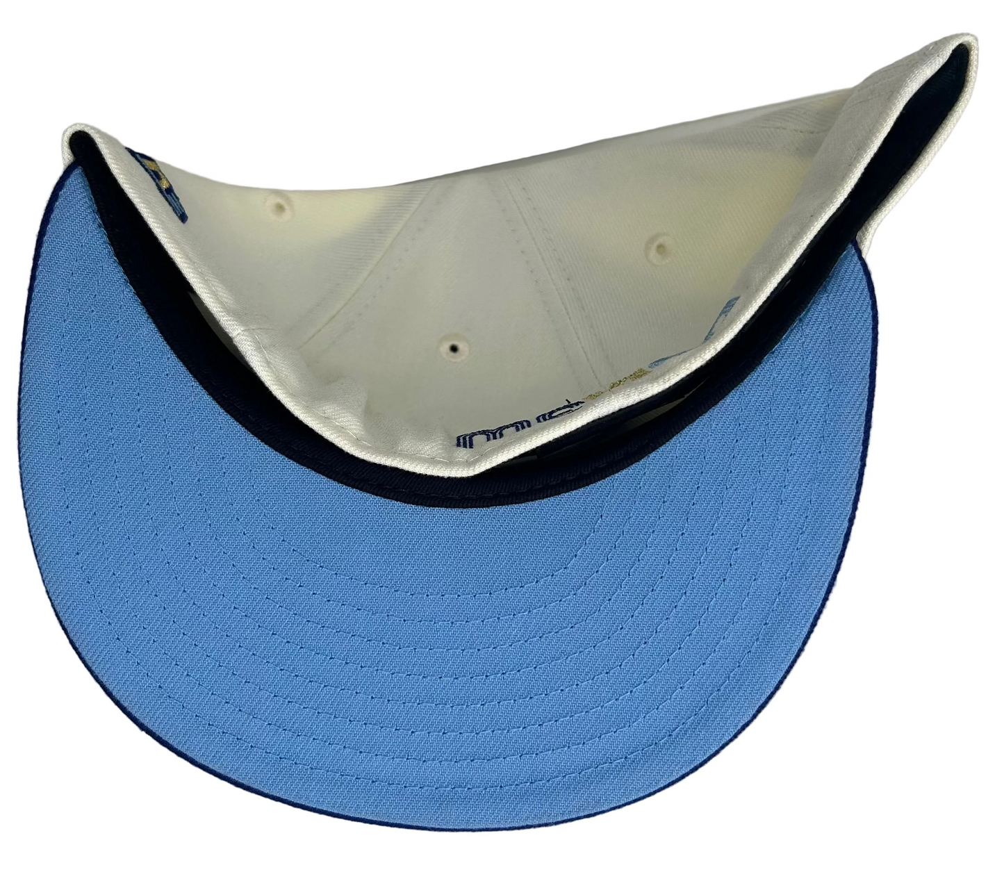 New Era 59FIFTY fitted hat features a two-tone design with a cream crown and royal blue visor.