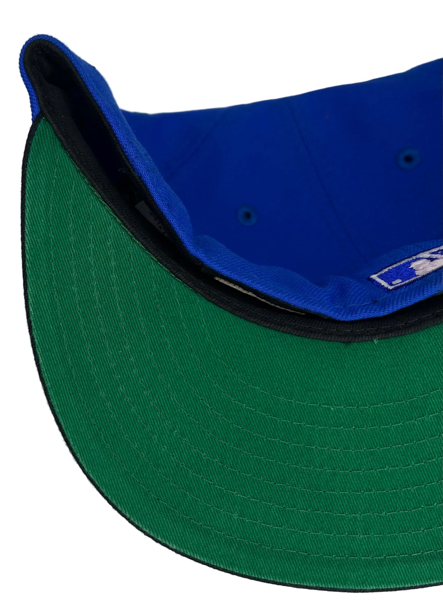 New Era 59FIFTY fitted Hat featuring a Cleveland Indians, royal blue crown, a navy blue visor, a green undervisor, and an Inaugural Season 1994 Jacobs Field side patch for the Cleveland Indians.