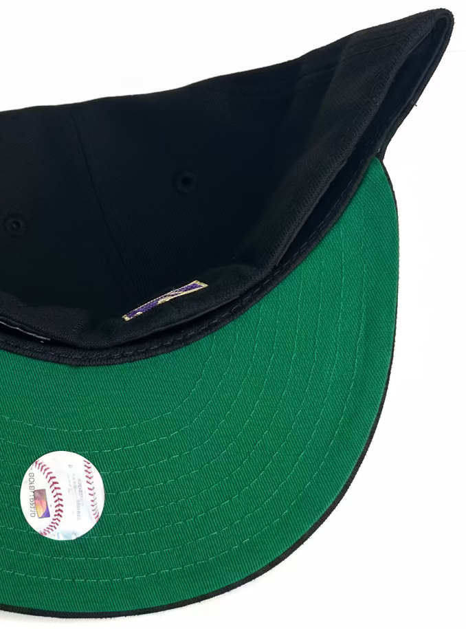 New Era Los Angeles Dodgers 59Fifty fitted cap featuring a black crown, royal blue and gold script lettering, and a commemorative side patch.