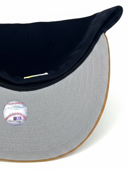 New Era Oakland Athletics 59FIFTY fitted hat featuring a navy crown, khaki visor, and a Stomper patch on the side.