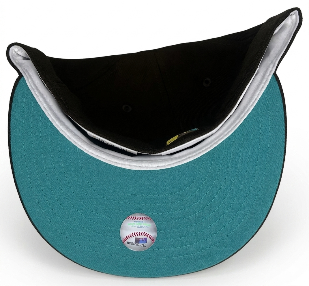New Era Seattle Mariners fitted hat features a brown crown with a gold "S" logo outlined in teal.