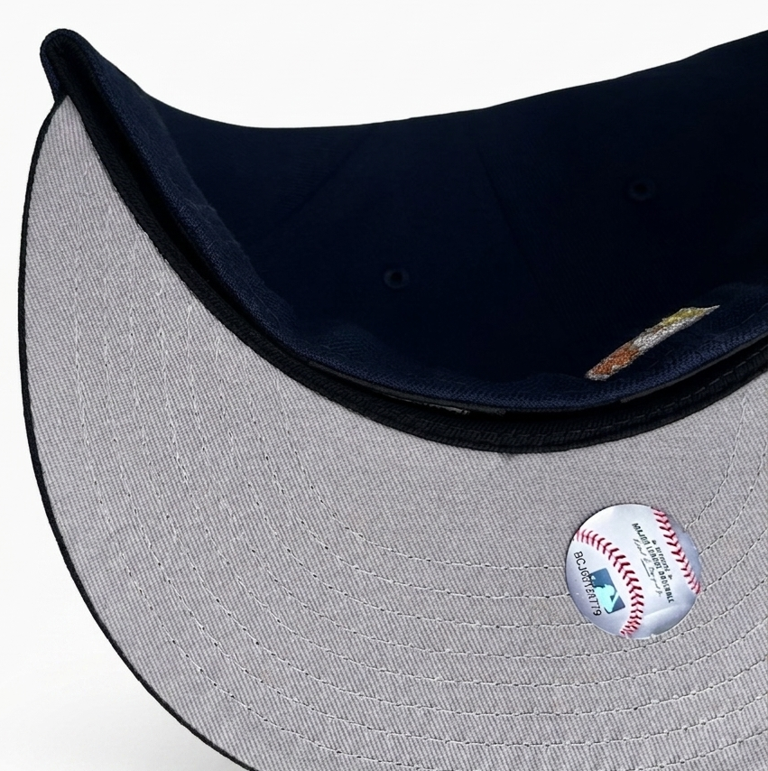 New Era 59FIFTY fitted hat featuring a navy crown, black visor, and a special 50th Anniversary side patch for the Anaheim Angels.