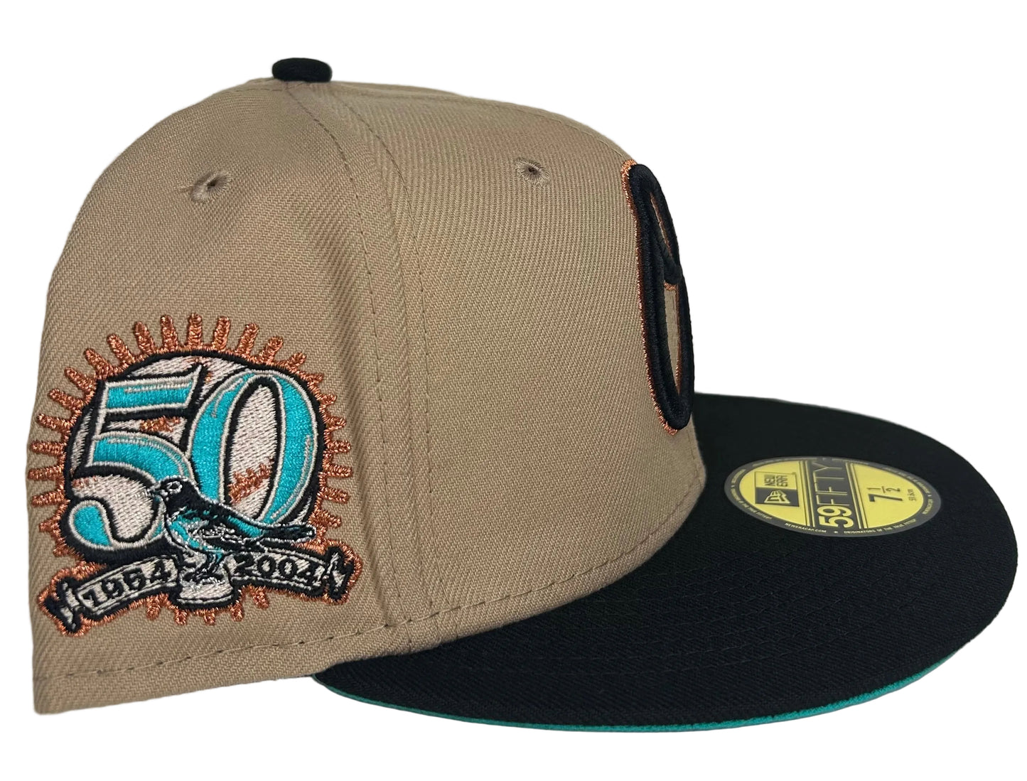 New Era Baltimore Orioles 59FIFTY fitted hat features a beige crown, black visor, and a 50th-anniversary patch on the side.
