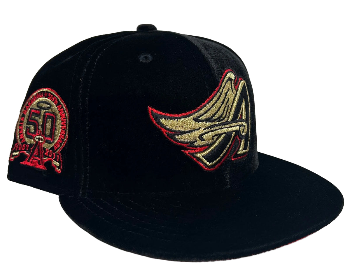 New Era Los Angeles Angels Black Velvet & Red UV 50th Anniversary fitted hat features a black crown, embroidered gold and red team logo, and a side patch celebrating the team's anniversary.