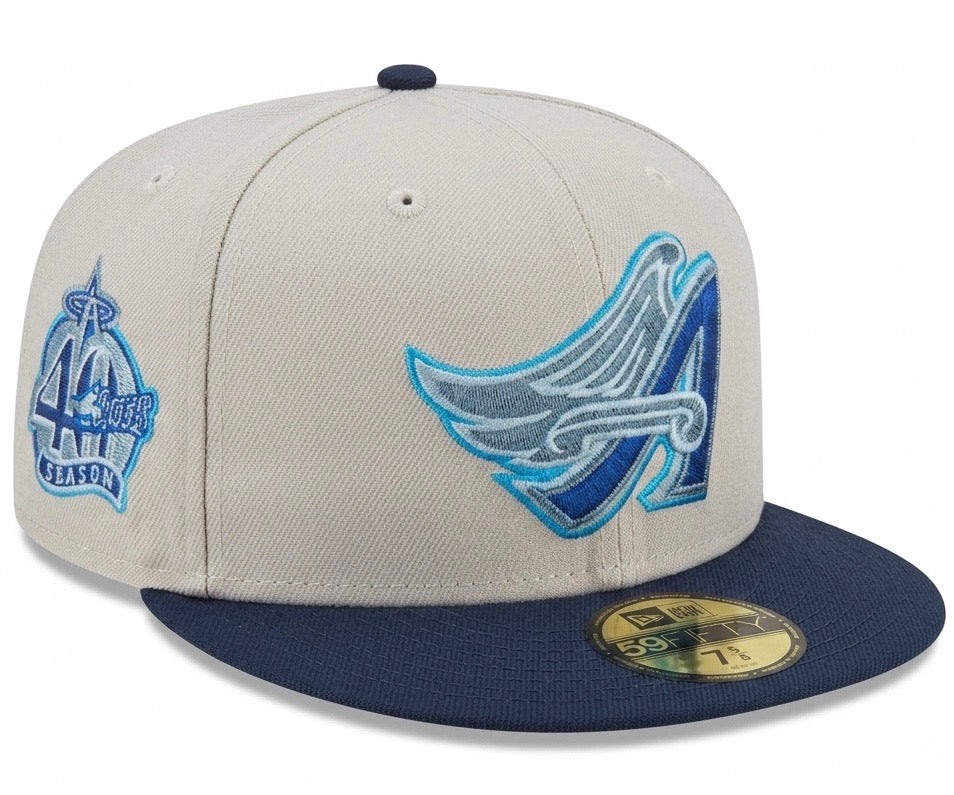 New Era 59FIFTY fitted hat features a white crown and blue visor with a Los Angeles Angels wing logo embroidered in blue tones.