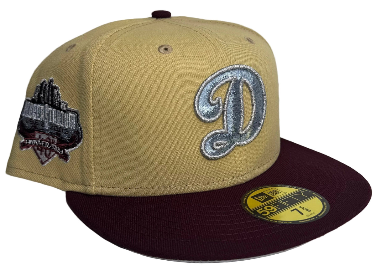 New Era Los Angeles Dodgers 59FIFTY fitted hat featuring a camel/vegas gold crown, a maroon visor, a silver script "D" logo, and a commemorative side patch.