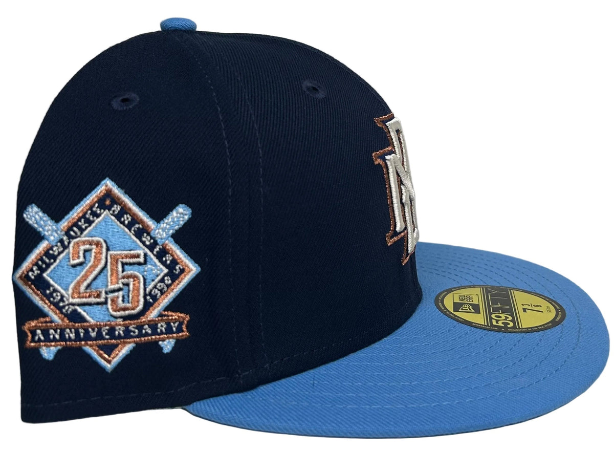 HC Exclusive Beer Pack Milwaukee Brewers 25th Anniversary Patch 59Fifty Fitted Hat in navy and light blue with an embroidered interlocking "M" logo on the front.