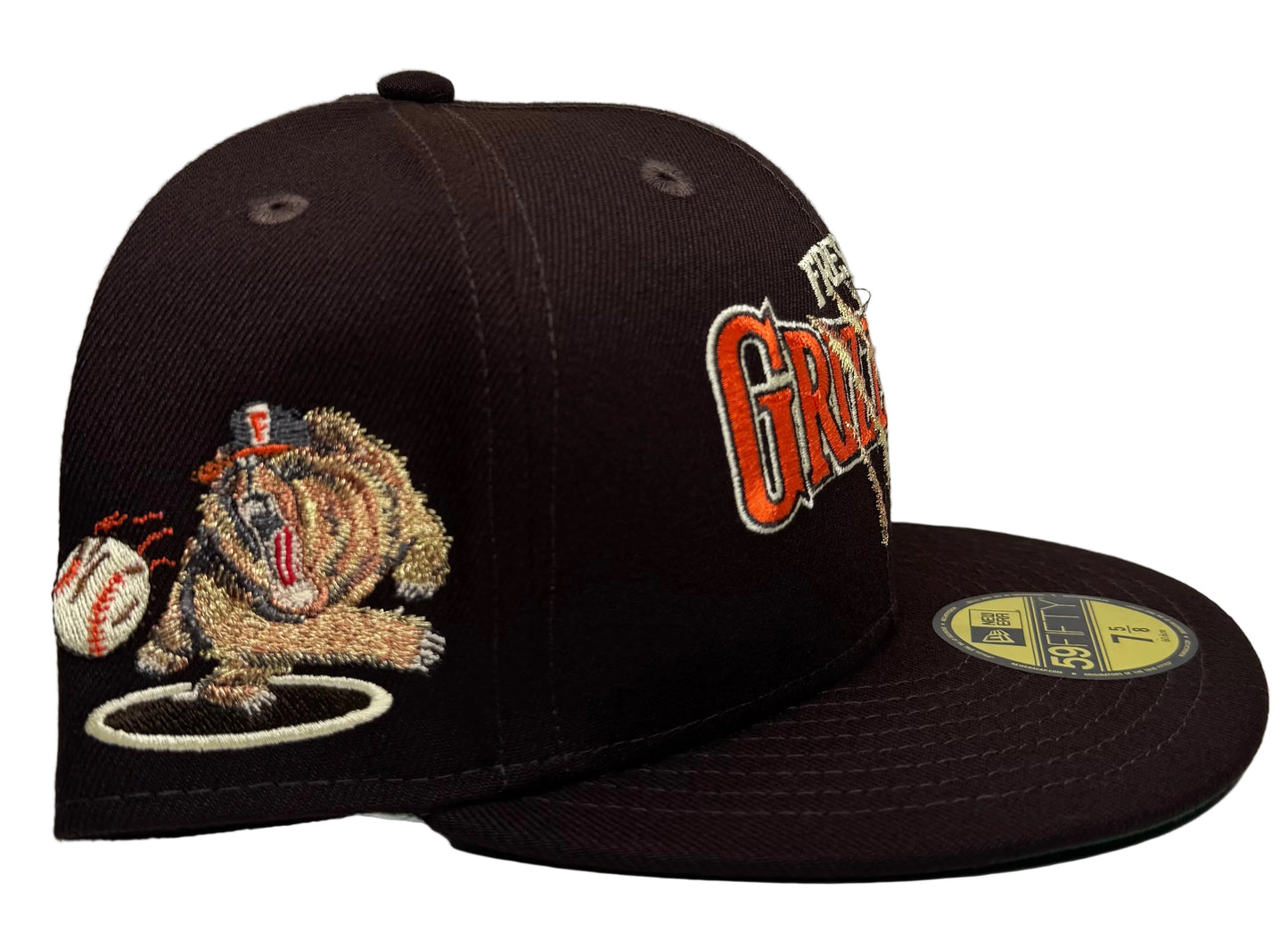 New Era Fresno Grizzlies fitted hat featuring a scratch-effect team logo and a green underbrim.