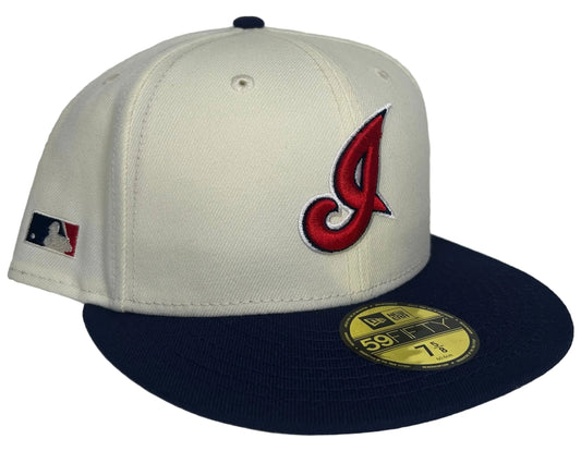 New Era 59FIFTY Cleveland Indians fitted cap featuring a cream-colored crown and a navy brim.