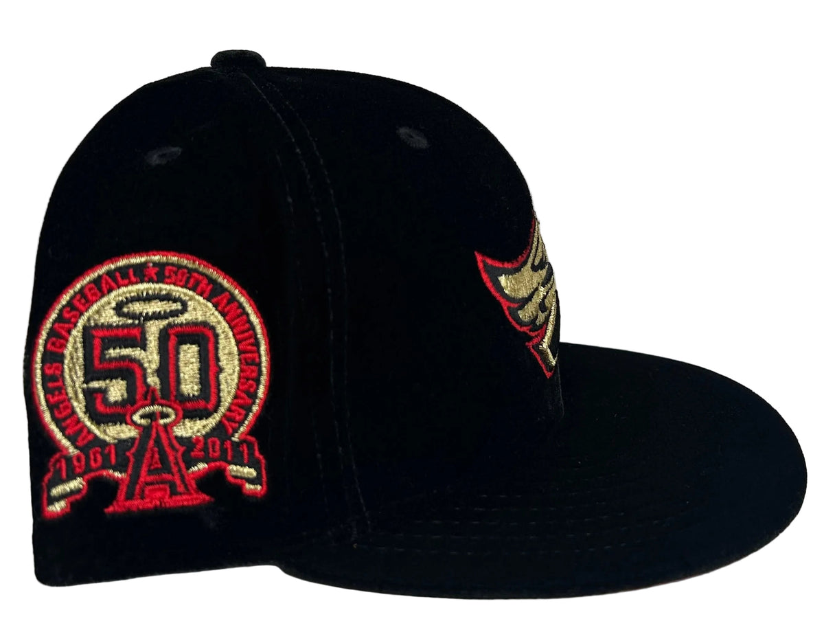 New Era Los Angeles Angels Black Velvet & Red UV 50th Anniversary fitted hat features a black crown, embroidered gold and red team logo, and a side patch celebrating the team's anniversary.
