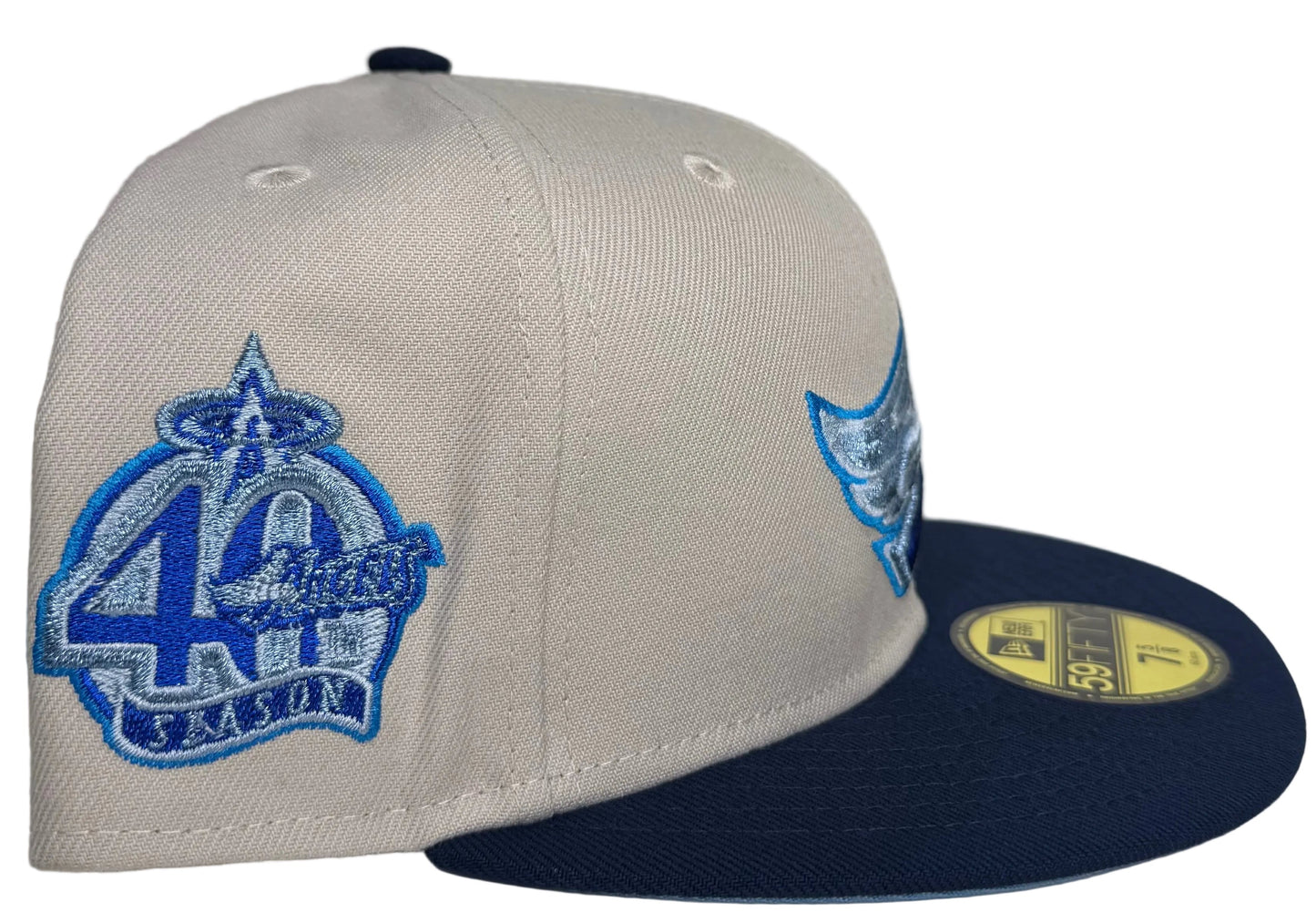 New Era 59FIFTY fitted hat features a white crown and blue visor with a Los Angeles Angels wing logo embroidered in blue tones.