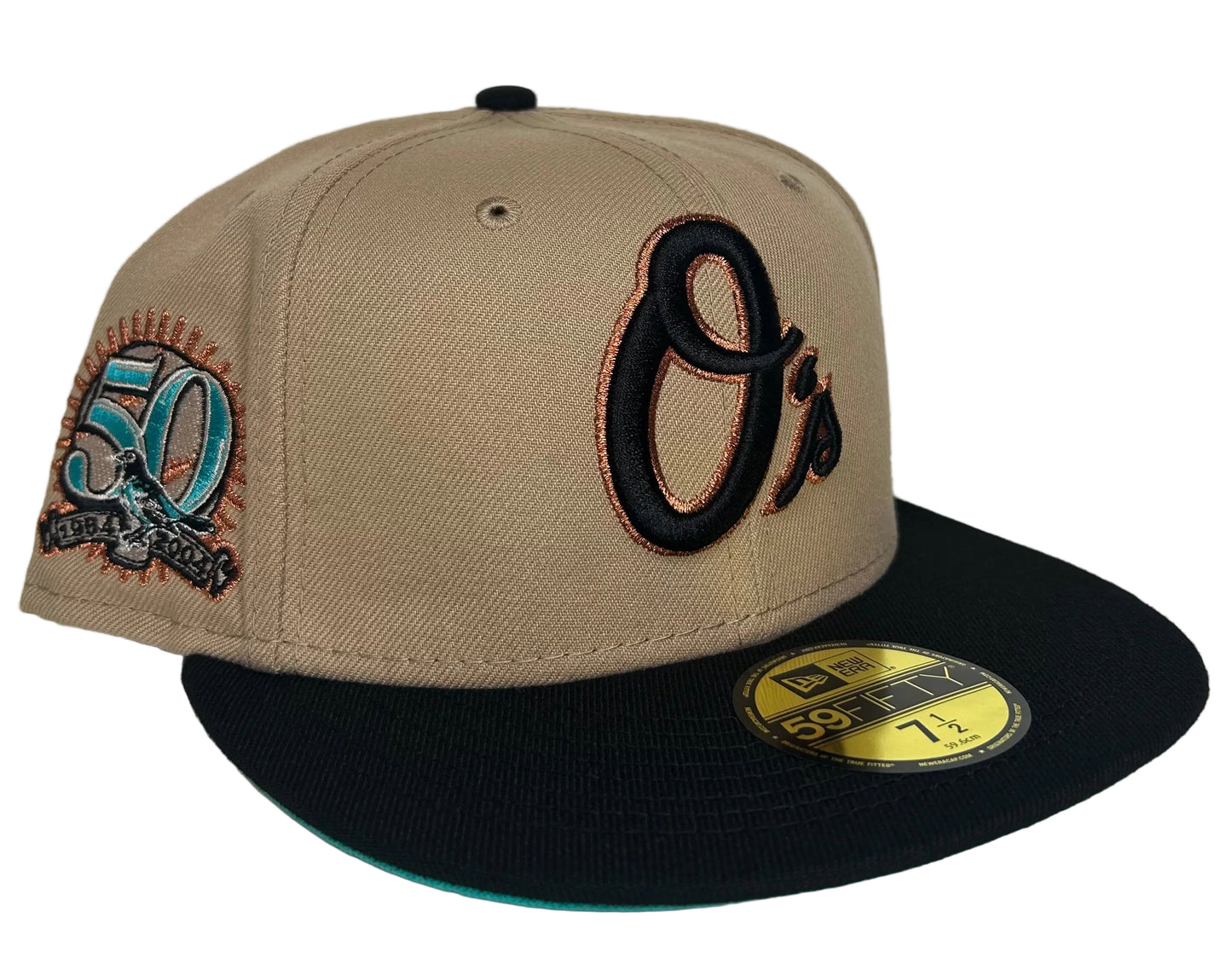 New Era Baltimore Orioles 59FIFTY fitted hat features a beige crown, black visor, and a 50th-anniversary patch on the side.