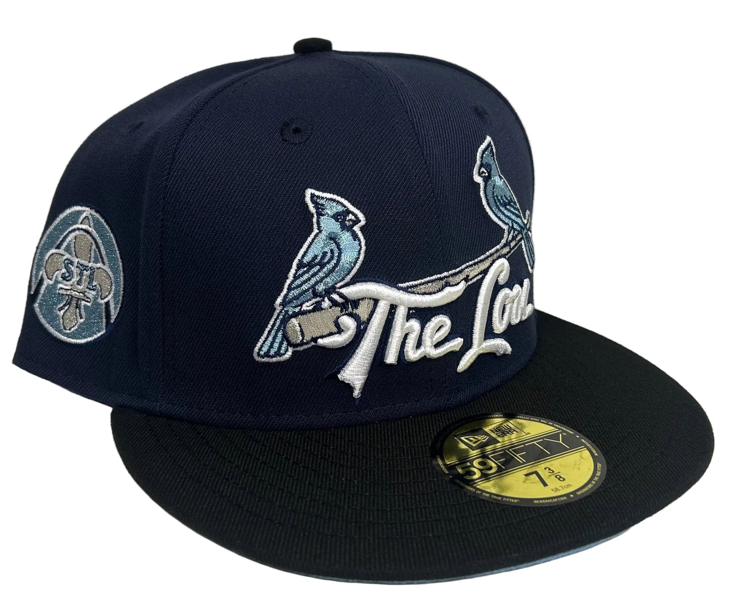 New Era 59Fifty St. Louis Cardinals "The Lou" fitted hat features a navy blue crown with light blue embroidery and a matching city patch.