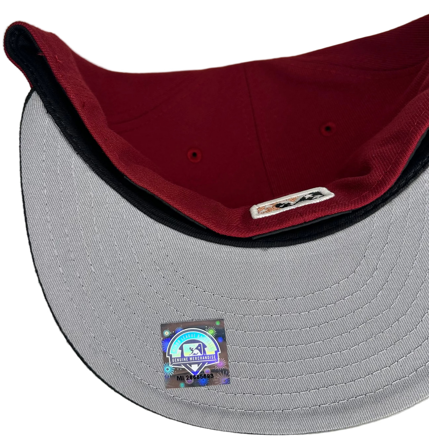 New Era Sugar Land Space Cowboys 59Fifty fitted hat features a maroon crown and black visor.