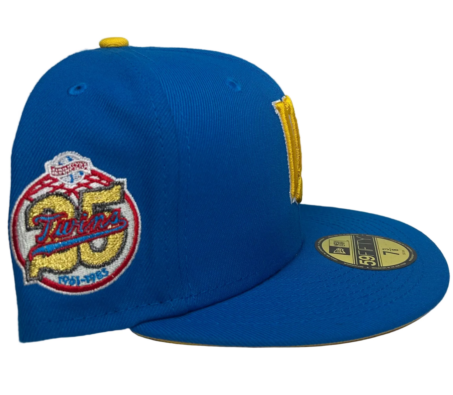 New Era Minnesota Twins Maggie Simpson Pack 59FIFTY fitted hat featuring a bright blue crown and a yellow interlocking 'M' logo inspired by The Simpsons.