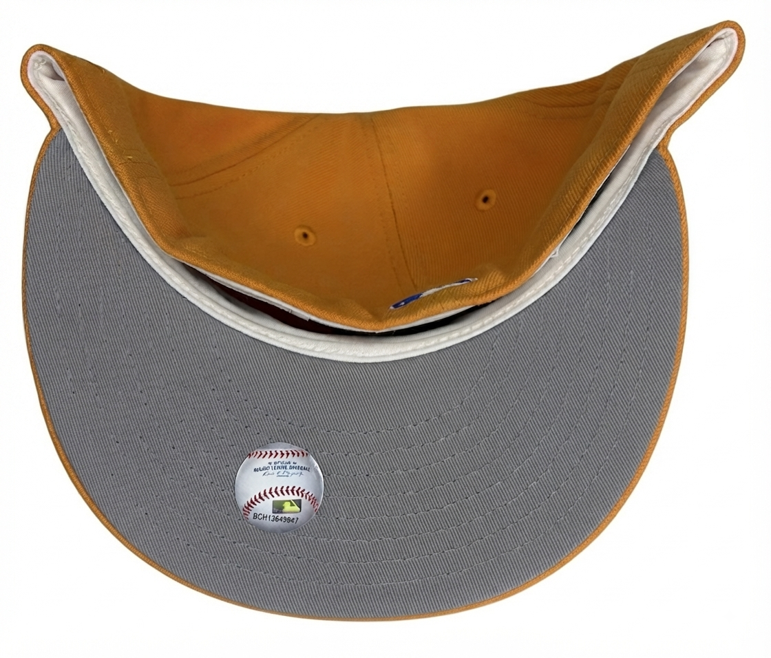 New Era 59FIFTY Minnesota Twins fitted hat features a vibrant orange and yellow colorway with a bold blue "M" logo and a commemorative side patch.