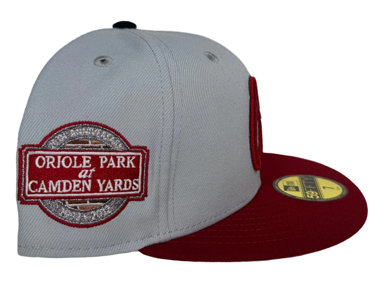 New Era 59Fifty Baltimore Orioles fitted hat featuring a light gray crown, a burgundy visor, and an Oriole Park at Camden Yards 20th anniversary side patch.