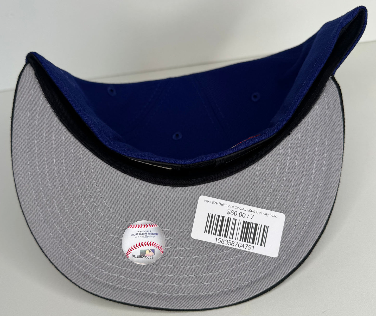 New Era 59FIFTY Baltimore Orioles fitted hat featuring a royal blue crown, a black flat brim, and a 2006 Battle of the Beltway side patch “Penny Foams” ATR By: T.V.B.