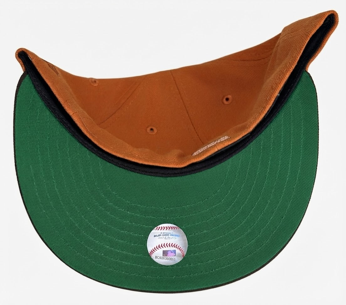 New York Yankees rust and walnut brown 59FIFTY featuring a cursive team script and a 1999 World Series side patch.