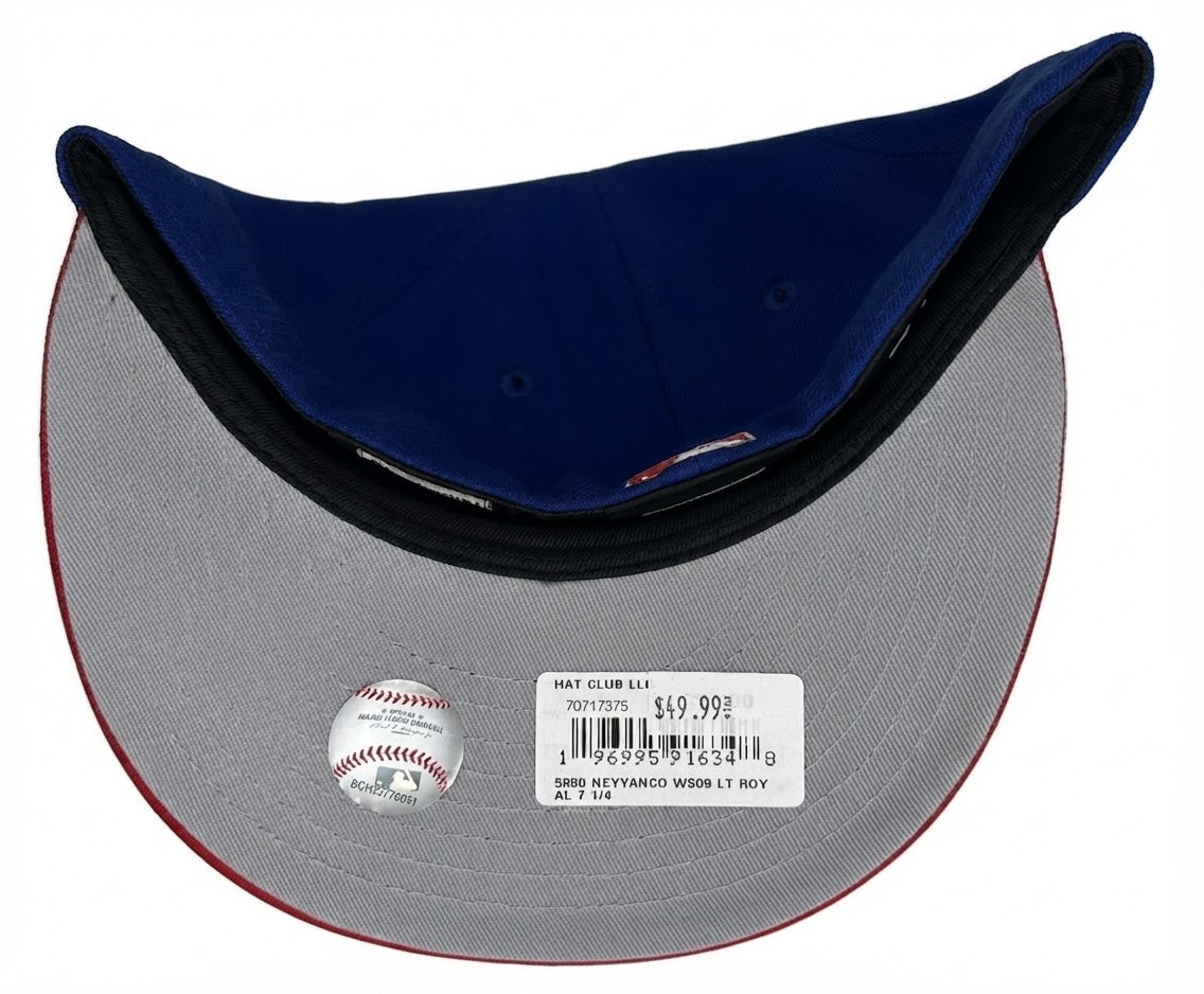 New Era 59FIFTY New York Yankees fitted hat featuring a royal blue crown, red flat visor, and a commemorative World Series side patch.