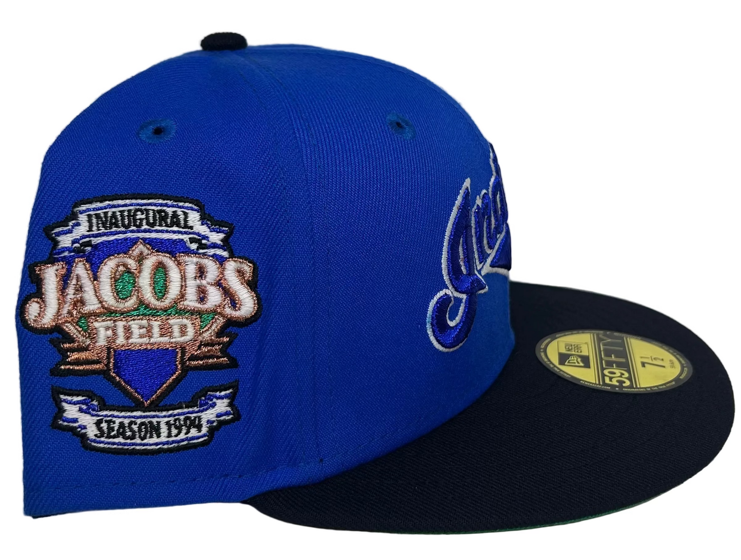 New Era 59FIFTY fitted Hat featuring a  Cleveland Indians, royal blue crown, a navy blue visor, a green undervisor, and an Inaugural Season 1994 Jacobs Field side patch for the Cleveland Indians.