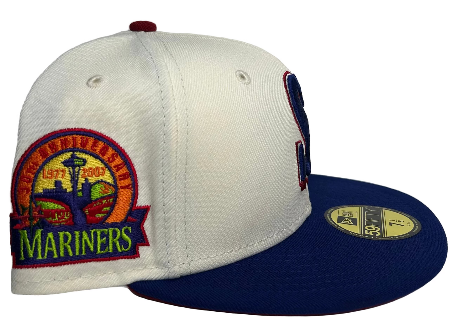 New Era 59FIFTY Seattle Mariners 30th Anniversary fitted hat with an off-white crown, royal blue brim, and a retro "S" logo.