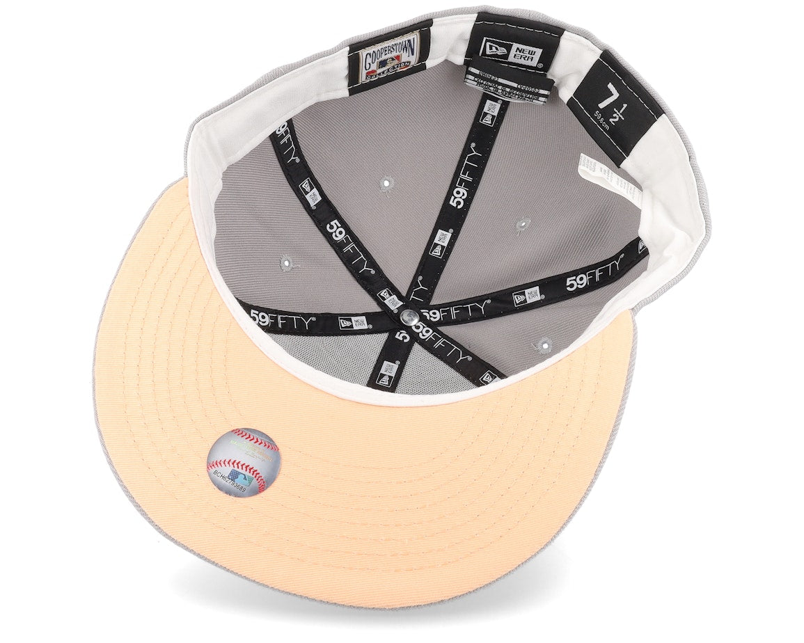 New Era Los Angeles Angels Feather 59FIFTY Fitted Cap featuring a gray crown, peach-colored detailing, and a 50th-Anniversary side patch. 