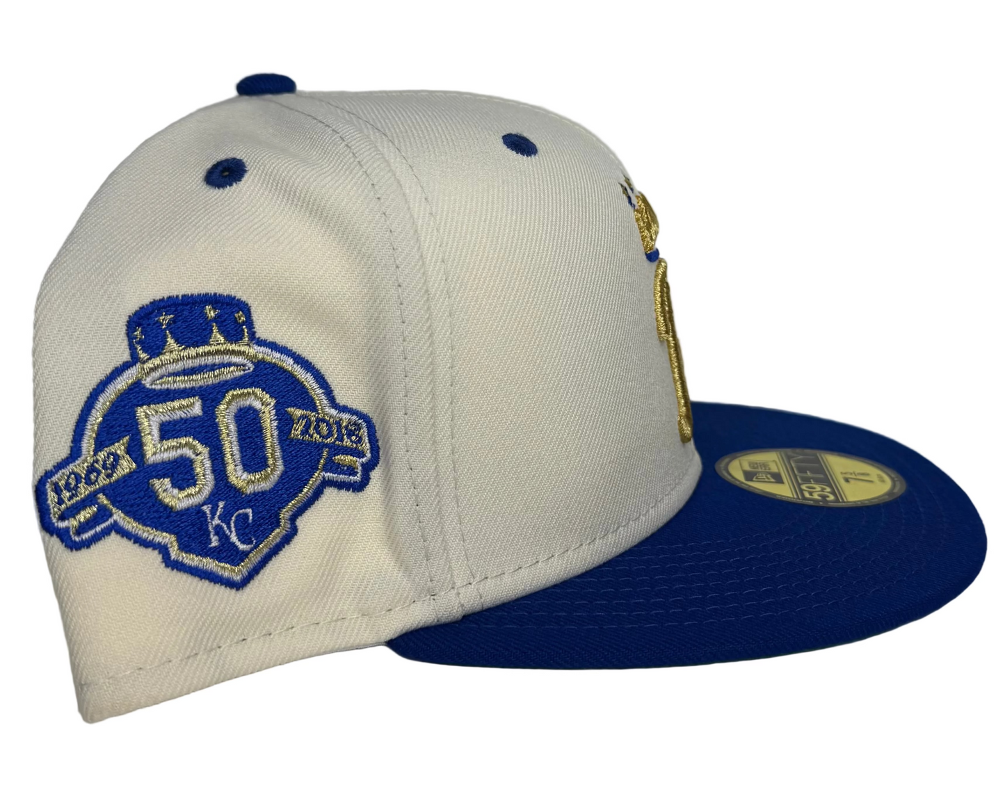 New Era Kansas City Royals 59FIFTY fitted cap features an off-white crown, royal blue visor, and a gold embroidered "R" logo with a crown on top.