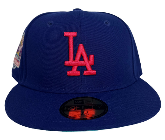 New Era 59FIFTY Los Angeles Dodgers Fitted Hat in a royal blue colorway featuring a Hot Pink embroidered "LA" logo.