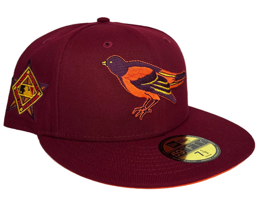 New Era Baltimore Orioles 59FIFTY fitted hat, specifically a HC Exclusive "Badlands" edition featuring a burgundy colorway and an orange undervisor. 