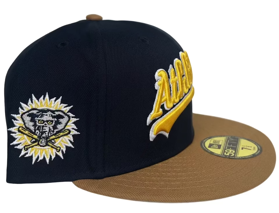 New Era Oakland Athletics 59FIFTY fitted hat featuring a navy crown, khaki visor, and a Stomper patch on the side.