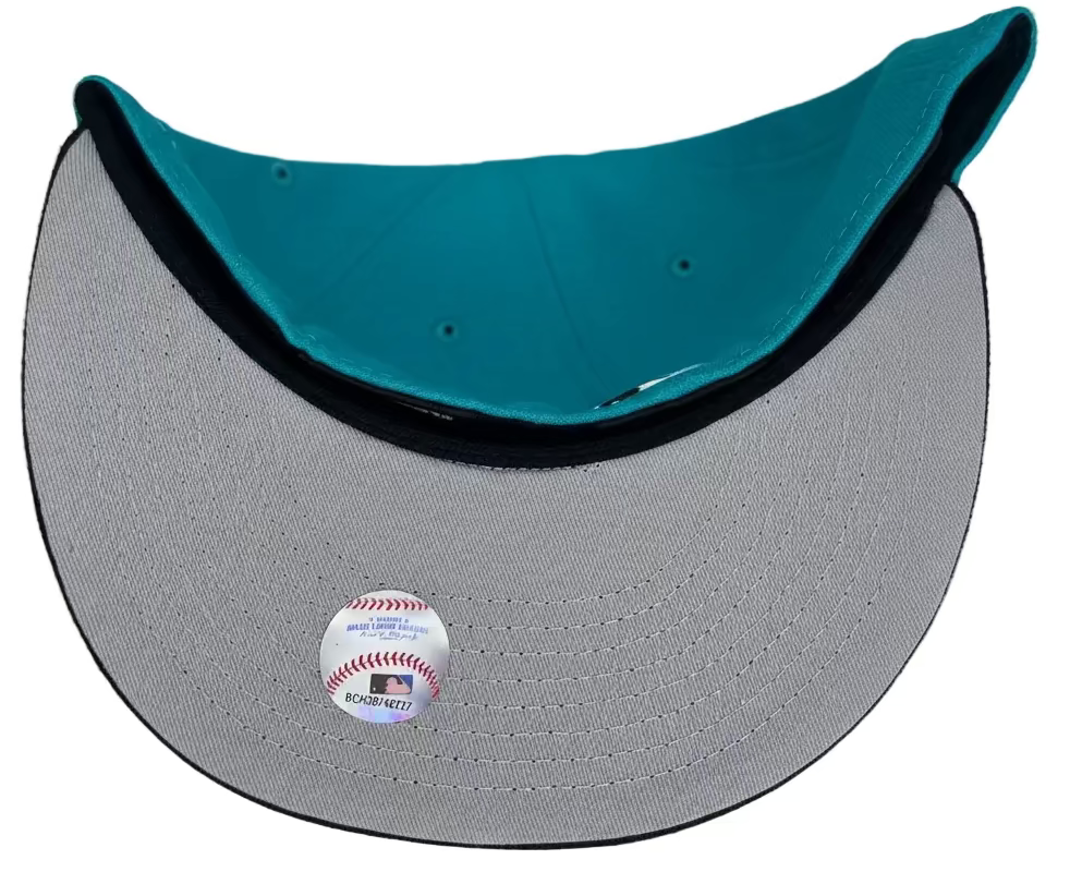 New Era Oakland Athletics 59FIFTY fitted hat featuring a teal crown, black visor, and a special 25th Anniversary side patch.