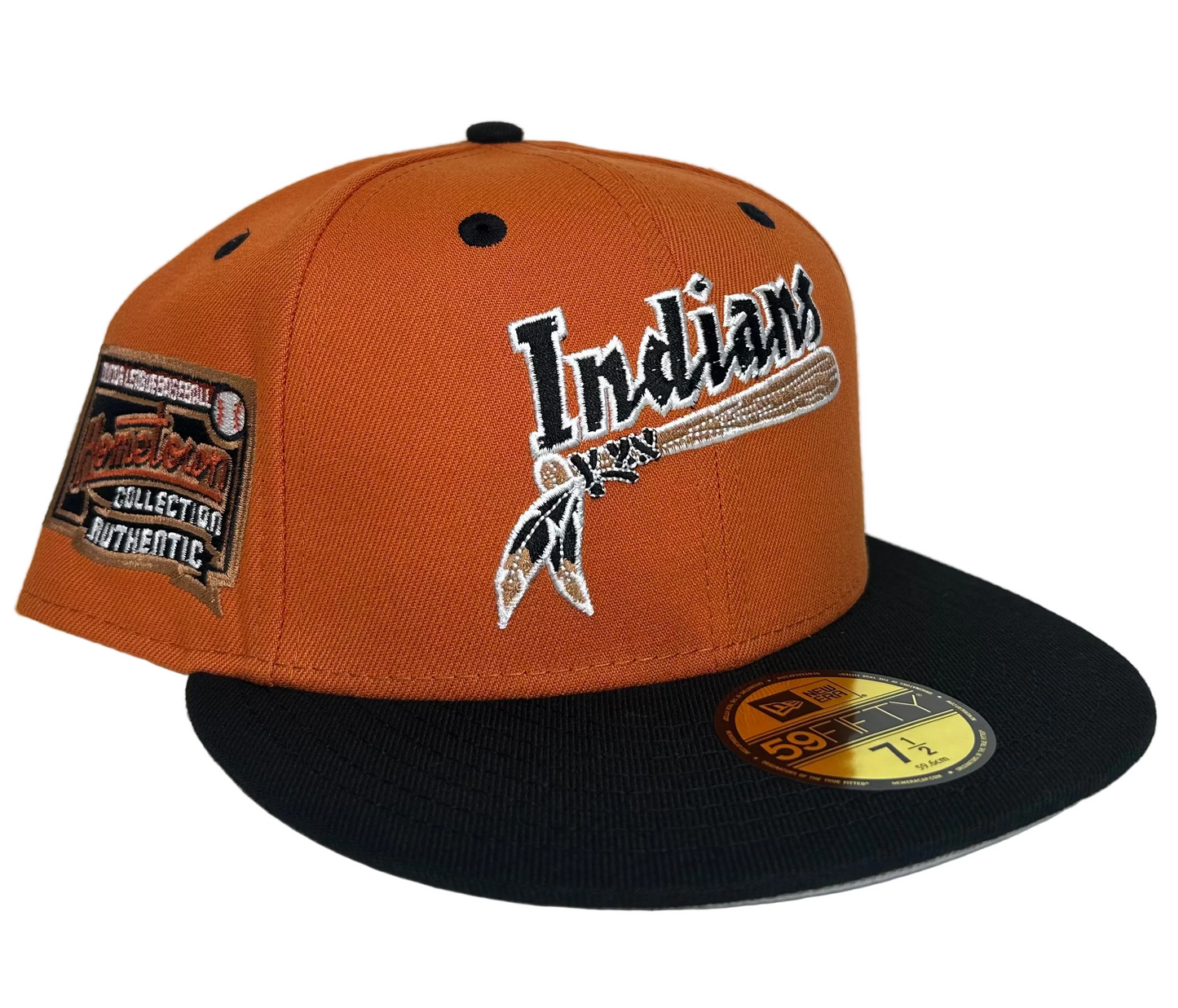New Era 59FIFTY fitted hat features an orange crown and a black visor with a throwback Cleveland Indians "Hometown Collection" logo patch on the side.