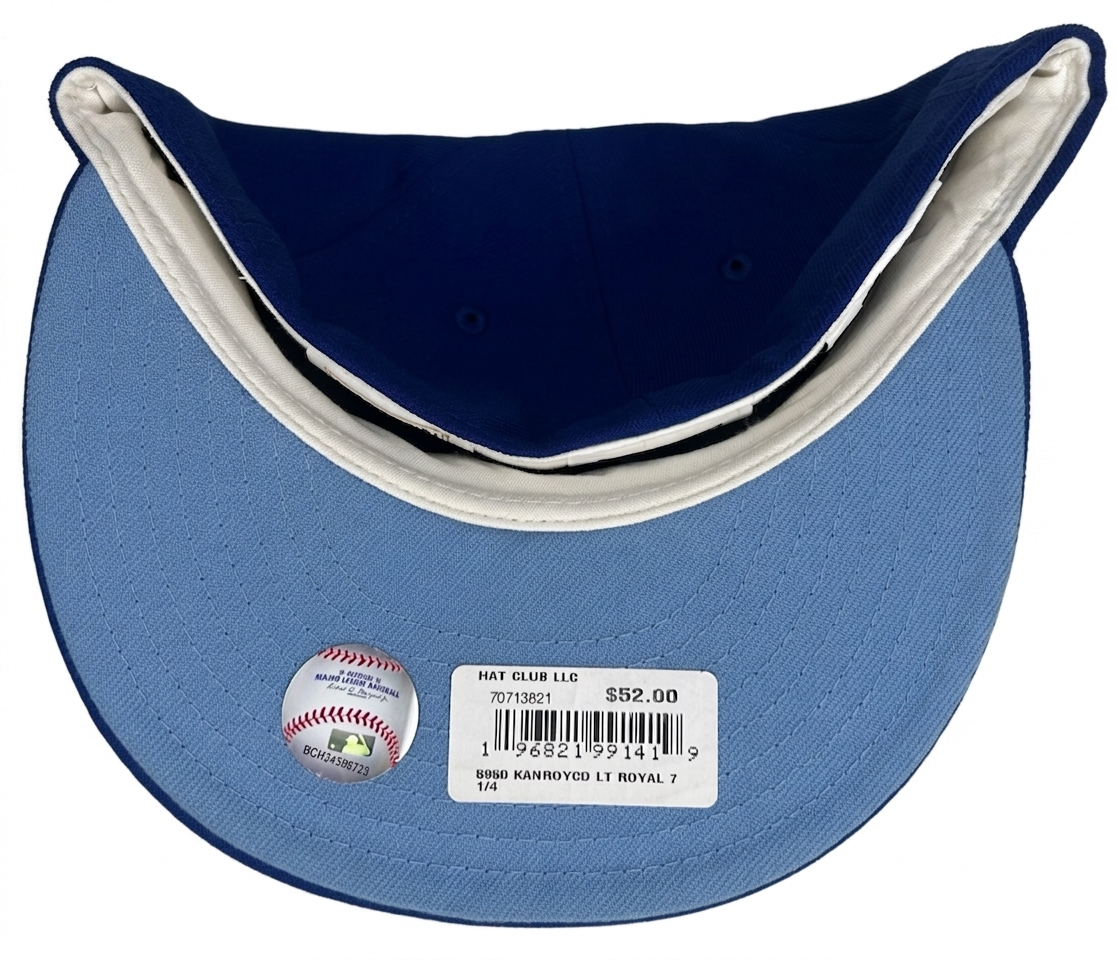 Kansas City Royals New Era 59FIFTY fitted cap features a light blue script logo against a royal blue crown and a 25th-anniversary patch.