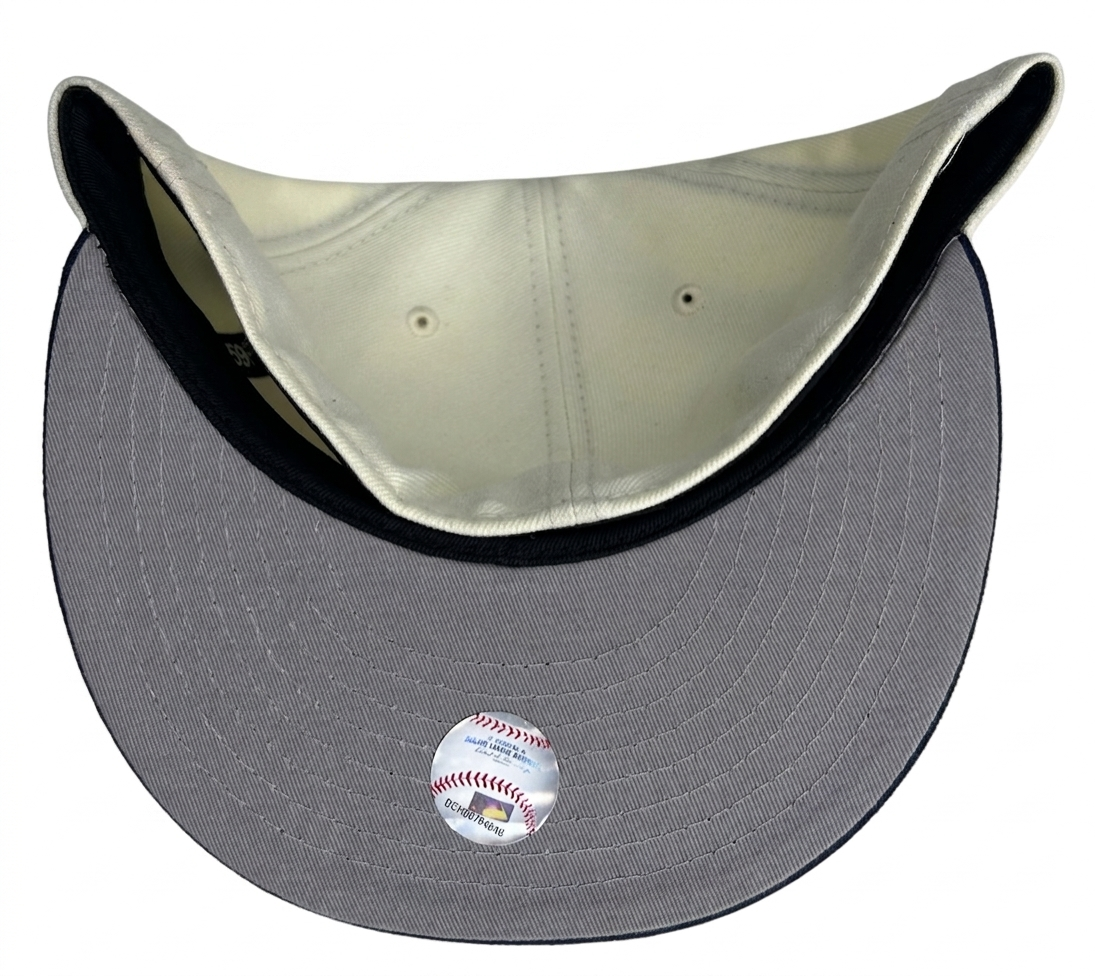 New Era 59FIFTY Cleveland Indians fitted cap featuring a cream-colored crown and a navy brim.