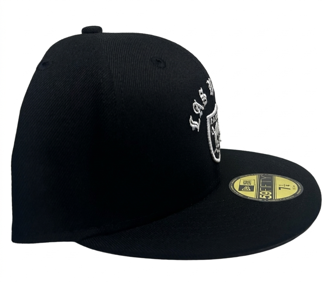 New Era Las Vegas Raiders "Gothic Arch" 59FIFTY fitted hat features white embroidered gothic-style "LAS VEGAS" lettering above the official team logo.